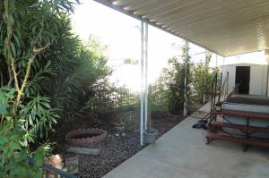 Accessibility ramp to front door and view of storage shed